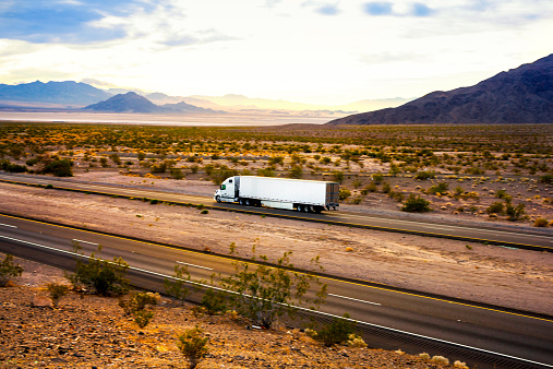 Photo of a semi truck, on the road.