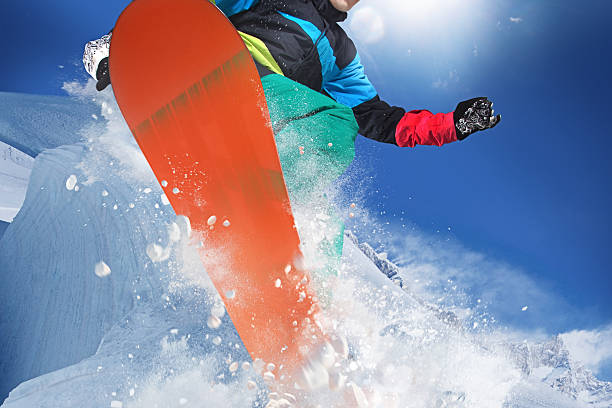 istock Snowboarder at jump in high mountains 527841989