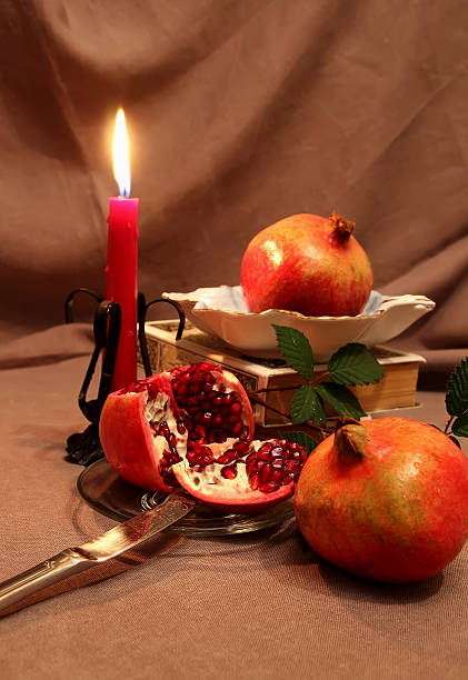 istock Still life with pomegranates and candle. 527842363