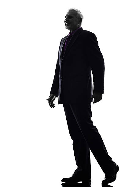 istock senior business man walking silhouette 527842617