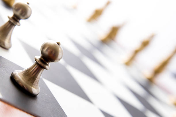 istock chess game - view of playing pieces on chessboard 527844157
