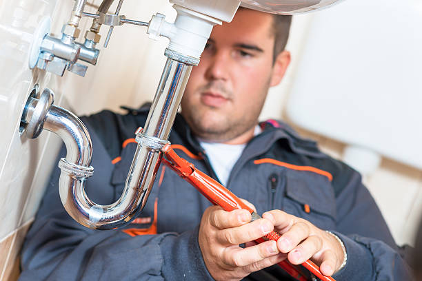 Plumber Photo of plumber repairing drain. kitchen sink photos stock pictures, royalty-free photos & images