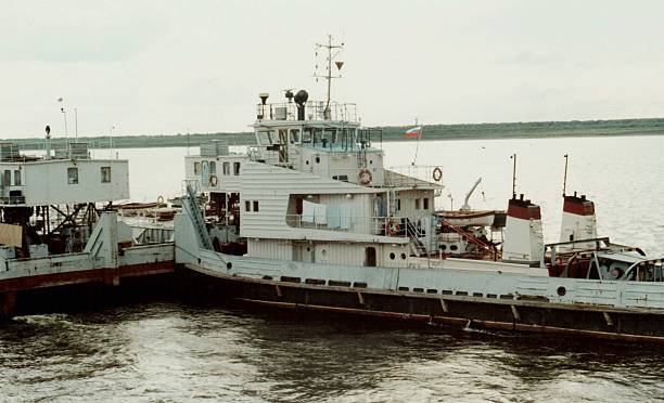 istock River tugboat pushing a barge, retro photo. 527857063