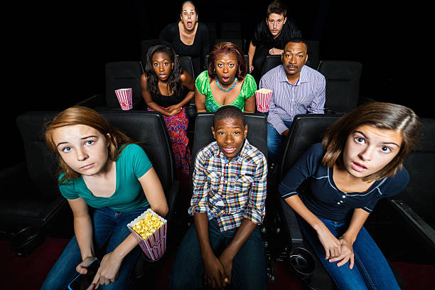 istock Surprised movie watchers making face at screen in theater 527857555