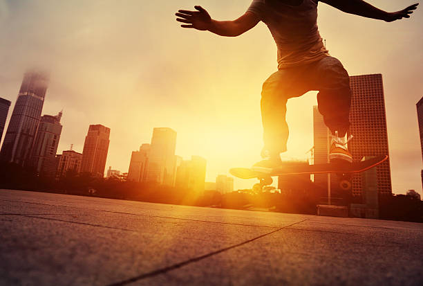 istock skateboarding woman jumping at  sunrise 527857725