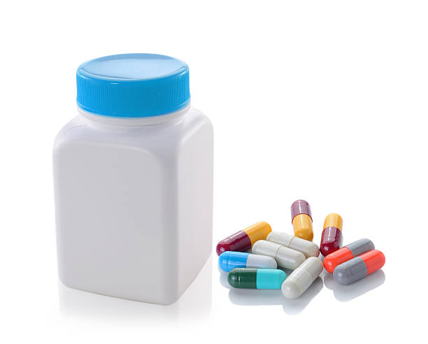 istock pills out of bottle on white background 527857923