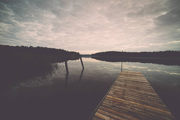 istock reflection of clouds in the lake with boardwalk. Vintage. 527858083