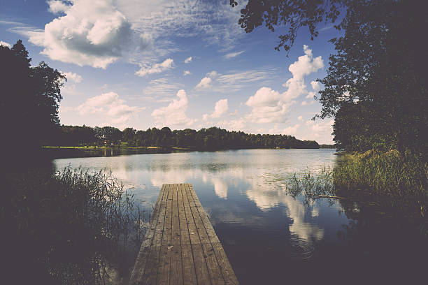 istock reflection of clouds in the lake with boardwalk. Vintage. 527858099