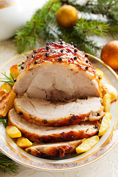 istock Roast pork with orange glaze, decorated with cloves. 527858235