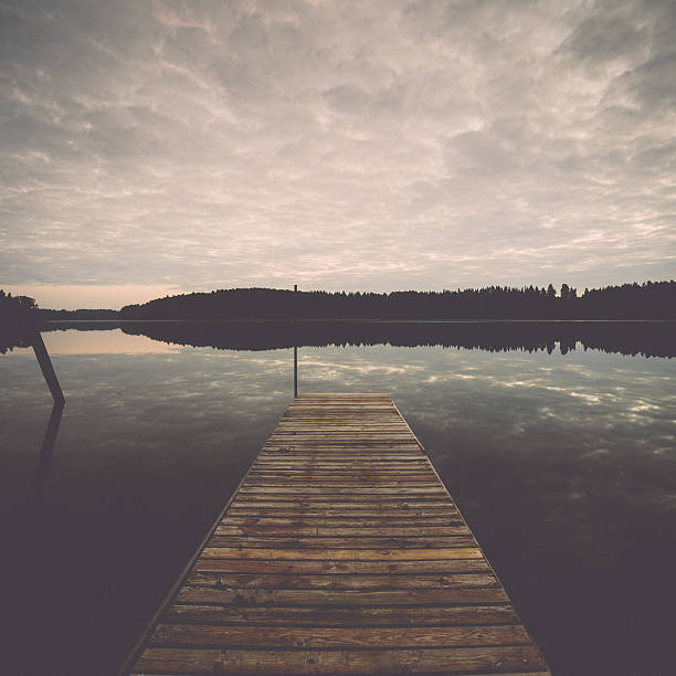 istock reflection of clouds in the lake with boardwalk. Vintage. 527858457