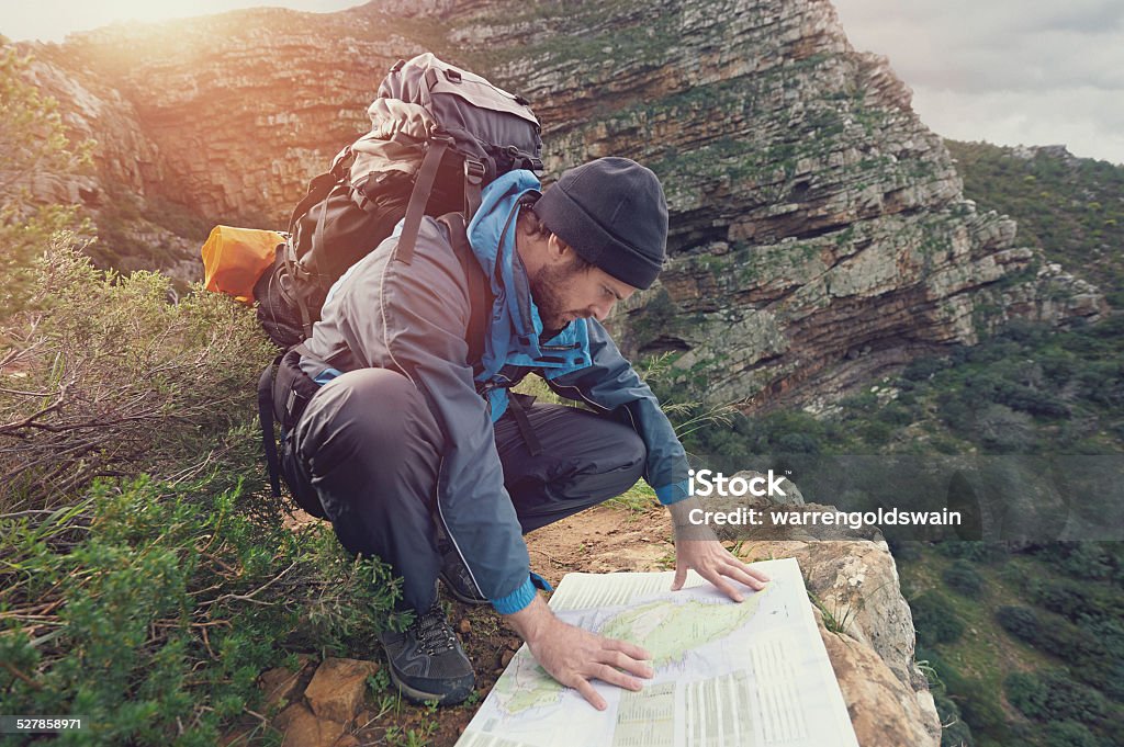 lost mountain man Lost hiker with backpack checks map to find directions in wilderness area Men Stock Photo