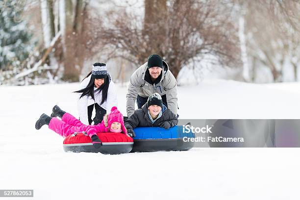 Family Tubing In Winter Stock Photo - Download Image Now - 10-11 Years, 30-39 Years, 6-7 Years