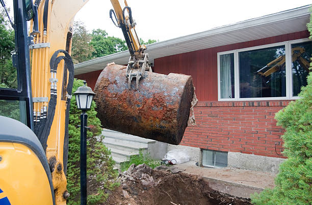 old rusted oil tank being removed from ground stock photo