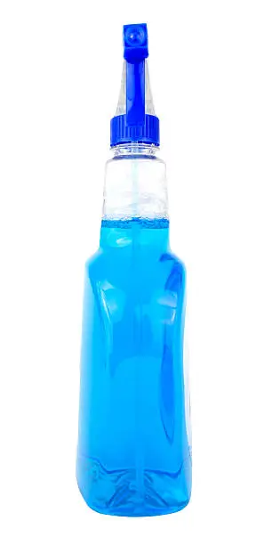 Spray bottle of blue window cleaner. No label. Vertical.