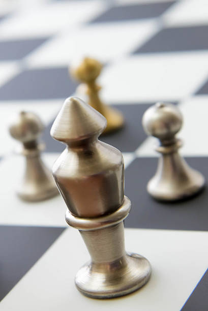 istock chess game - view of playing pieces on chessboard 527863215
