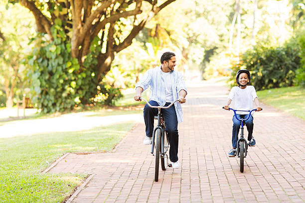 istock indian father and daughter riding bikes together 527863243