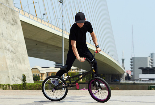 A BMX rider doing tricks out in the city