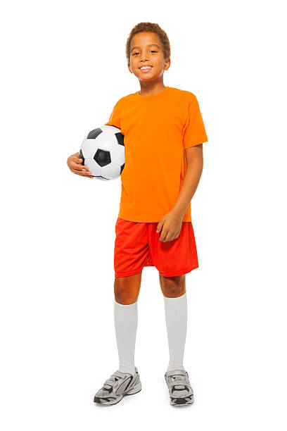 маленький африканский мальчик держит футбольный мяч изолированные - soccer child little boys playing стоковые фото и изображения