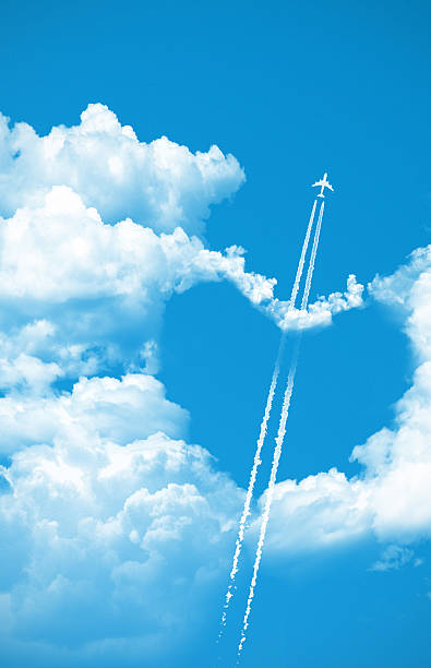 Airplane fly over a heart on the sky Airplane fly over a heart on the sky, love concept words in the sky stock pictures, royalty-free photos & images