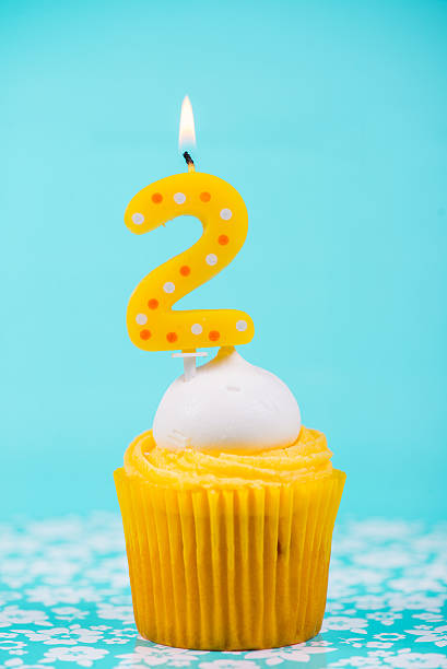 istock birthday cup cake with number two candle on blue background 527878305