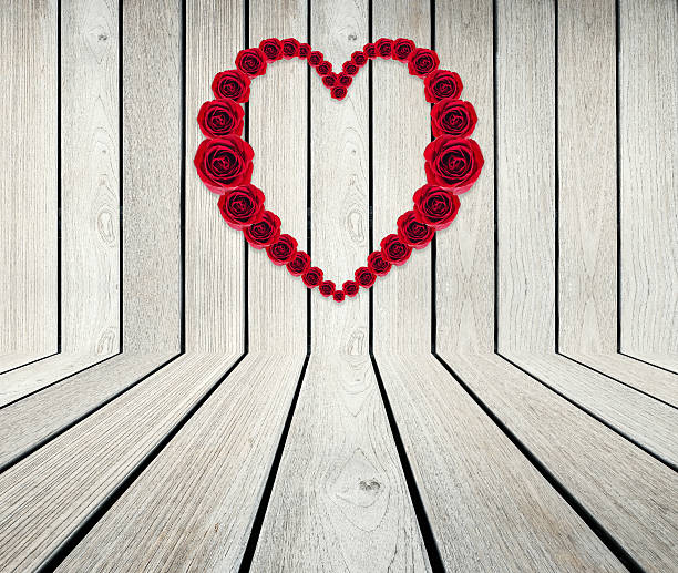 istock Heart Frame from red rose on wood 527878505