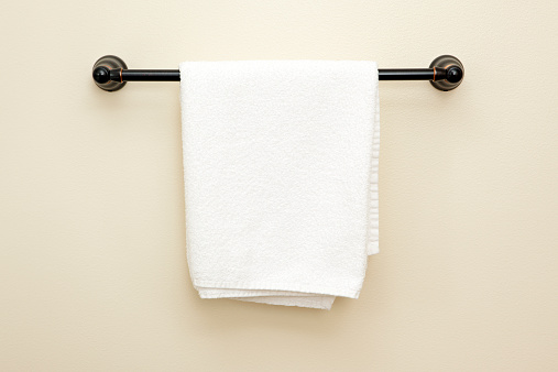 Bathroom towel hanging on a towel rack.