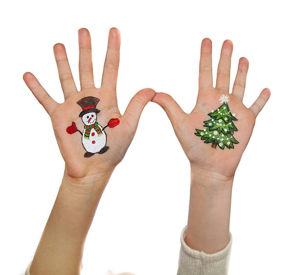 istock Christmas symbols painted on hands 527880441