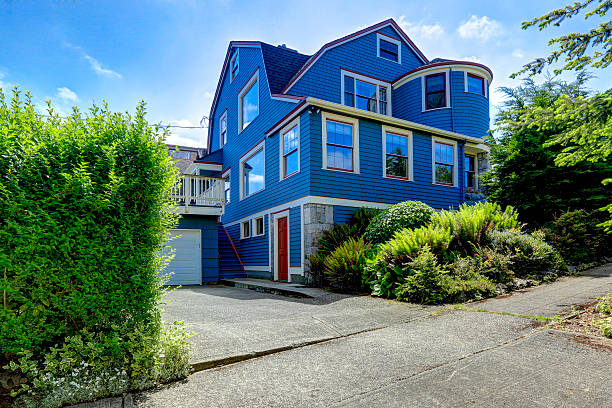 istock Big house exterior in blue color with red trim 527881009