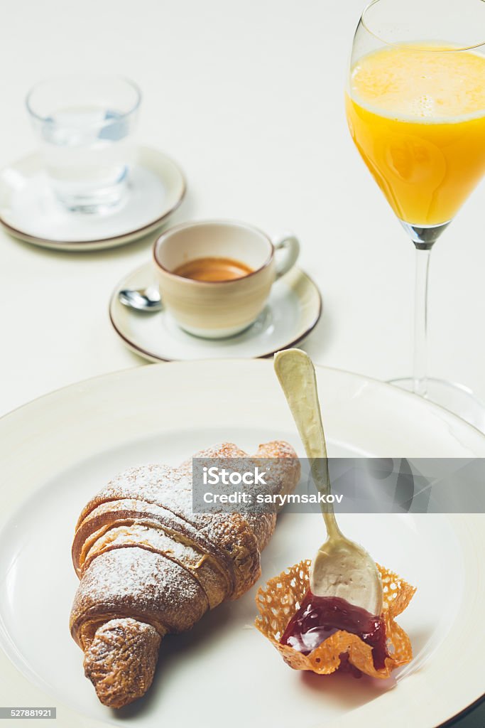 breakfast with croissant,coffee and juice breakfast with croissant,coffee and juice. Warm colors. Shallow dof. Bakery Stock Photo