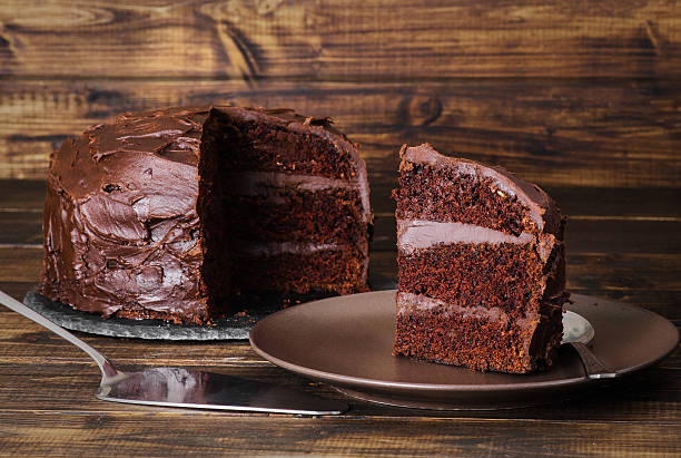 istock Chocolate cake on dark wooden bckground 527883454