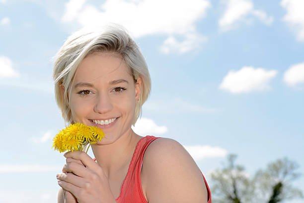 istock woman with dandelions 527883886