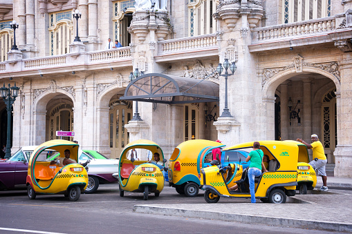 Havana, Cuba - April 16, 2016: Coco taxis in front of the Gran theatro de la Havana waiting for tourists