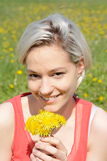 istock woman with dandelions 527884726