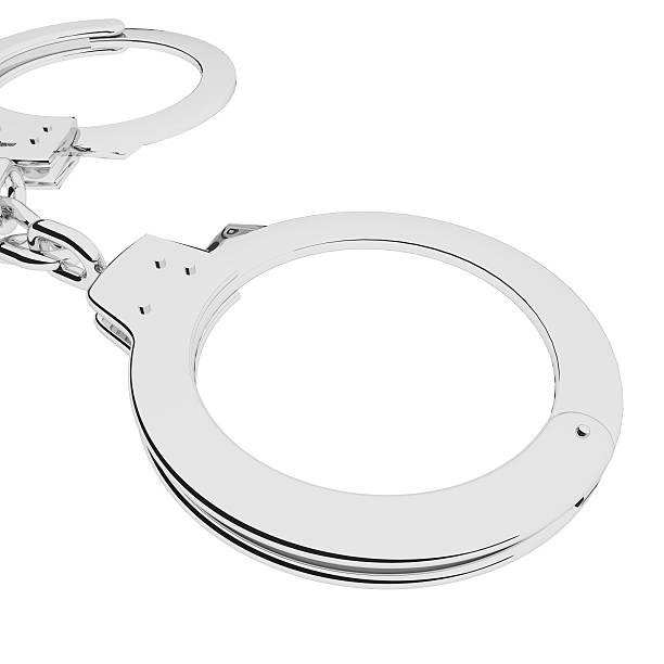 istock Metal handcuffs isolated over white 527886252