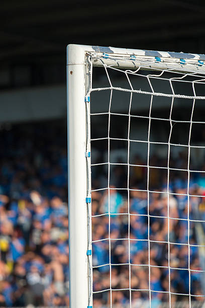istock Goal post with soccer fans in the background 527887826
