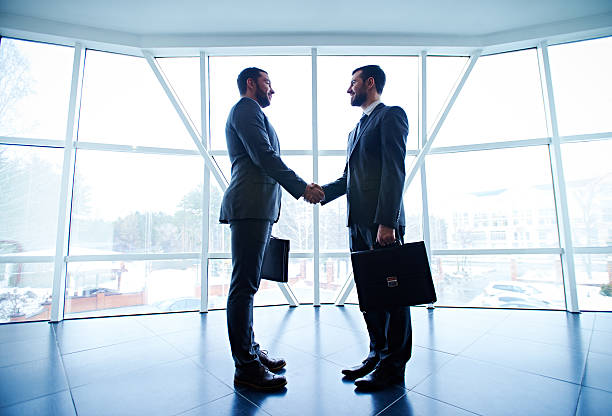 istock Business partners greeting 527888208