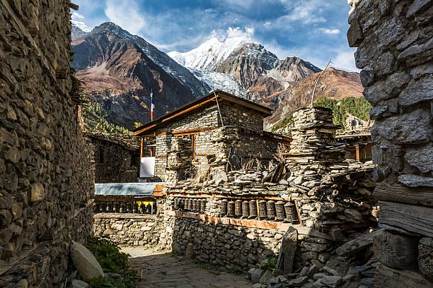 Traditional stone build village of Manang. Mountains in the background. stock photo