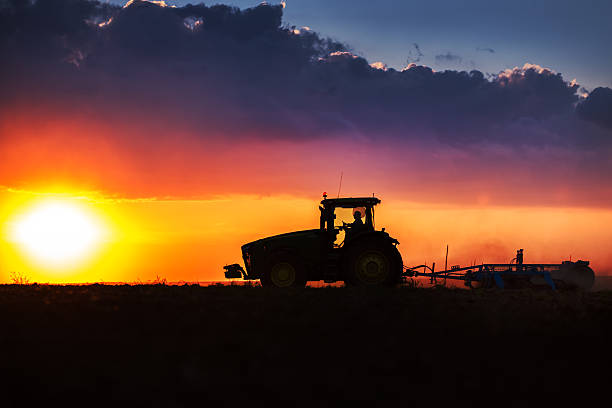 istock Farmer in tractor preparing land with seedbed cultivator 527889976