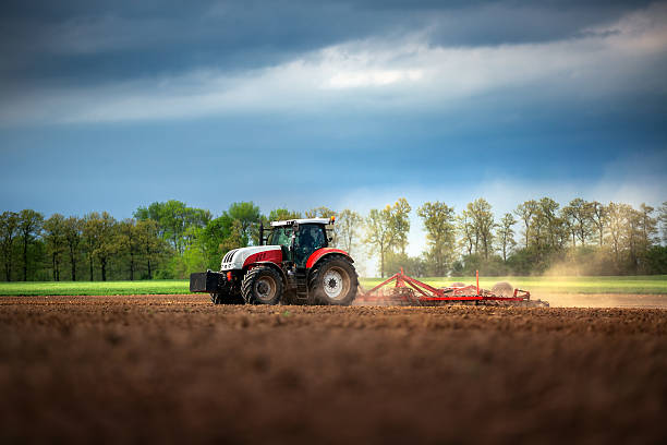 istock Farmer in tractor preparing land with seedbed cultivator 527890204