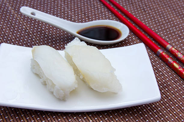 istock Nigiri with halibut on bamboo seen up close 527890496