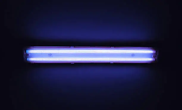 Photo of Detail shot of a fluorescent light tube on a wall.