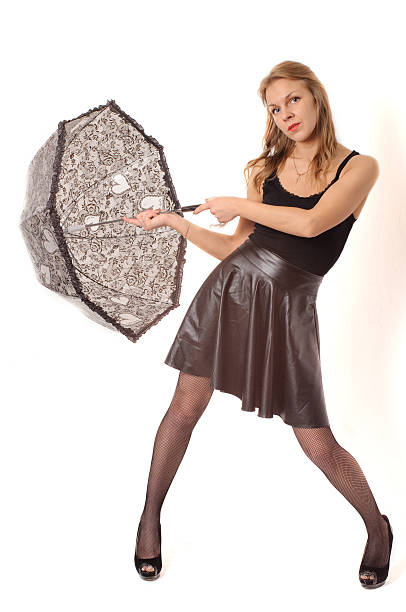istock Woman under black umbrella against the white wall 527891280