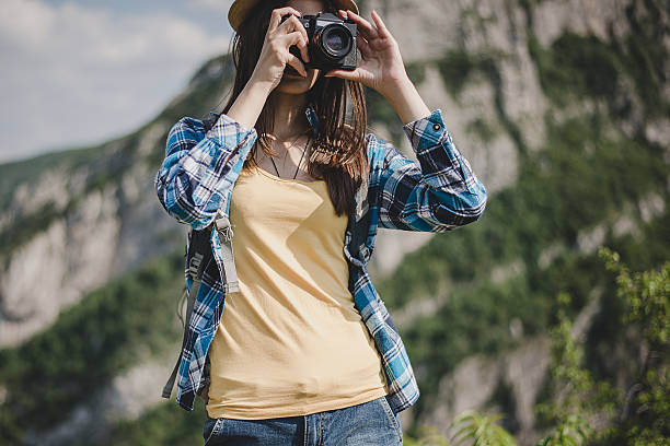 istock Young woman with backpack taking a photo 527891684
