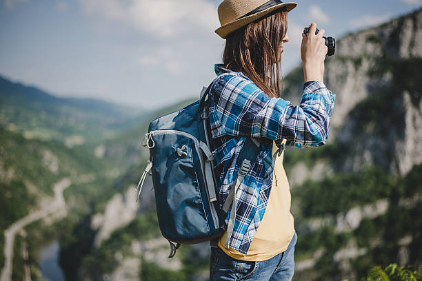 istock Young woman with backpack taking a photo 527892022