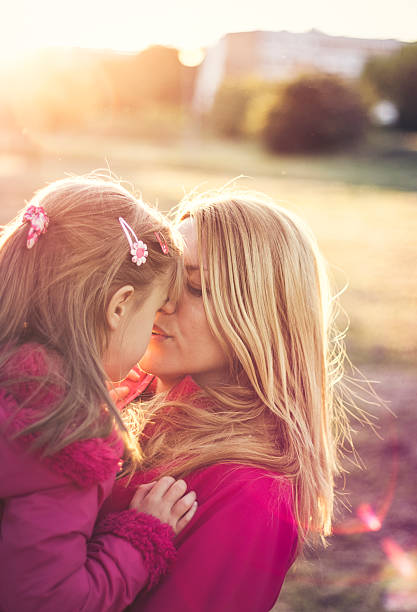 istock Mother and daughter enjoying themselves at sunset 527892074