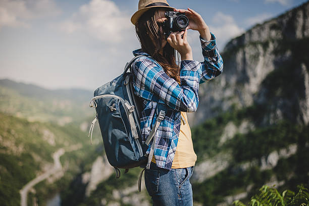 istock Young woman with backpack taking a photo 527892684