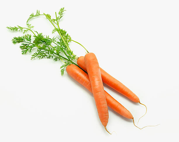 istock Sweet carrots with leafs isolated on white background 527892776