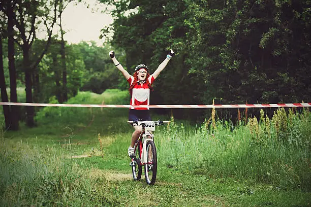 Photo of Young woman wins the race crossing finish line