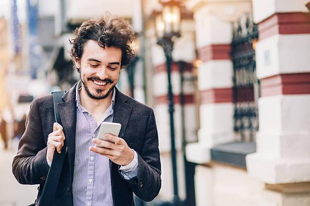 istock Man with phone on the street 527893366