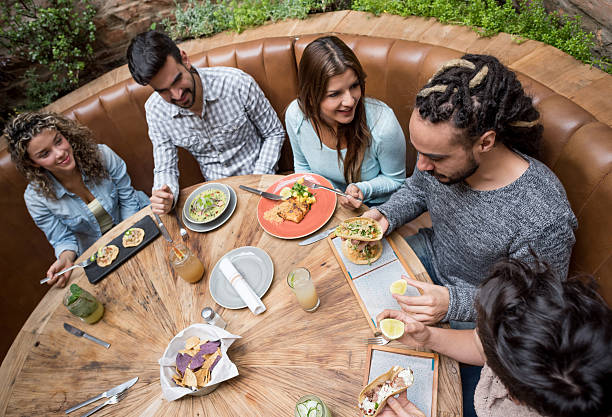 istock Happy friends eating at a restaurant 527894544